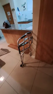 Fold up assisted walker.  Aluminum with wheels.