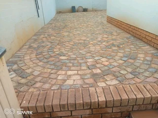 Brick paving and tar surfacing and brick paving