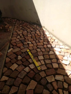 Brick paving and tar surfacing and brick paving