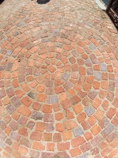 Brick paving and tar surfacing and brick paving