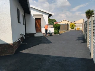 Tar surfacing and brick paving