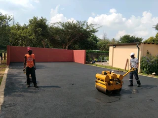 Tar surfacing and brick paving