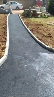 Tar surfacing and brick paving