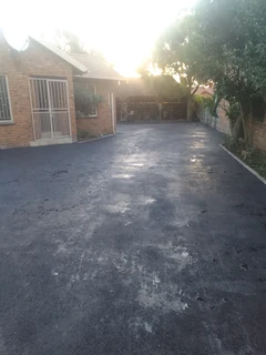 Tar surfacing and brick paving