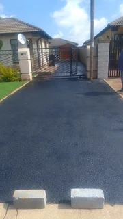 Tar surfacing and brick paving