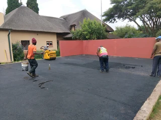 Tar surfacing and brick paving