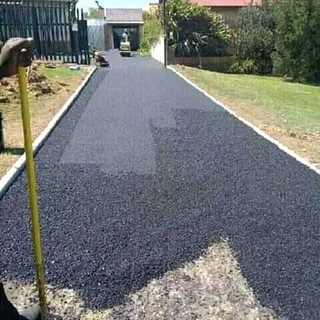 Tar surfacing and brick paving