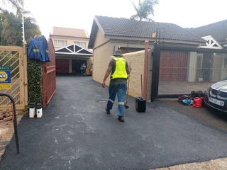 Tar surfacing and brick paving