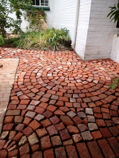 Tar surfacing and brick paving