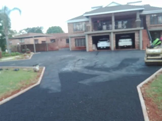 Tar surfacing and brick paving