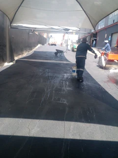 Tar surfacing and brick paving
