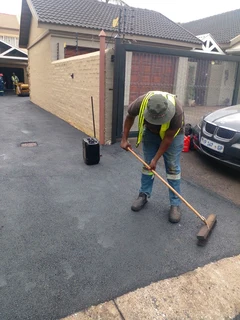 Tar surfacing and brick paving