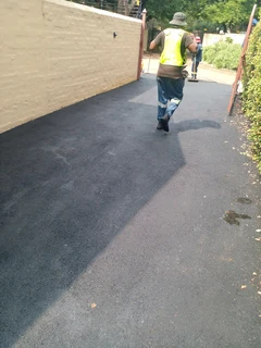 Tar surfacing and brick paving