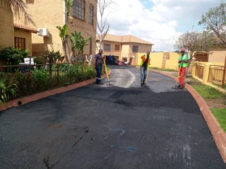 Tar surfacing and brick paving