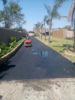 Tar surfacing and brick paving