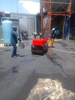 Tar surfacing and brick paving