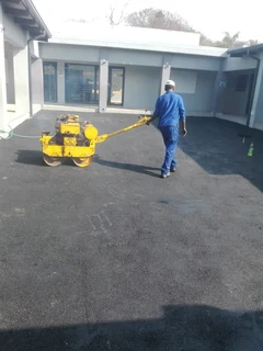 Tar surfacing and brick paving