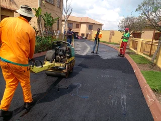 Tar surfacing and brick paving
