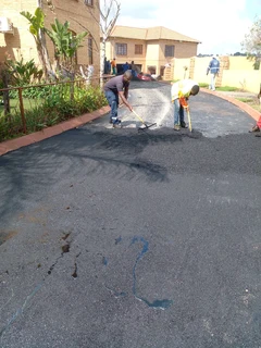 Tar surfacing and brick paving