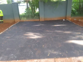 Tar surfacing and brick paving