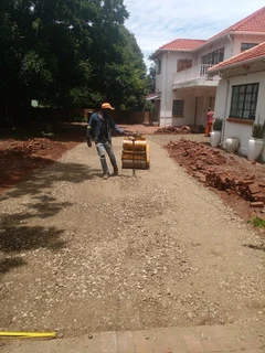 Tar surfacing and brick paving