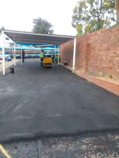 Tar surfacing and brick paving