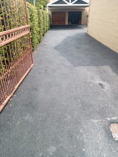 Tar surfacing and brick paving
