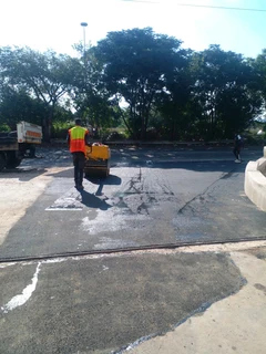 Tar surfacing and brick paving