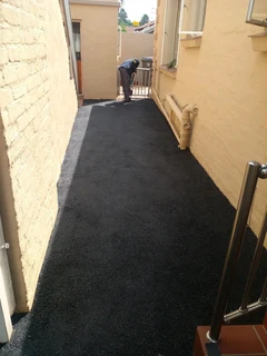 Tar surfacing and brick paving