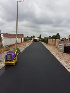 Tar surfacing and brick paving