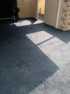 Tar surfacing and brick paving