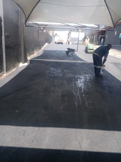 Tar surfacing and brick paving
