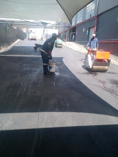 Tar surfacing and brick paving