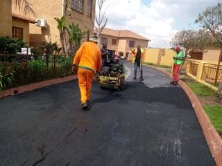 Tar surfacing and brick paving