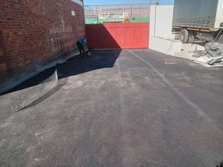 Tar surfacing and brick paving