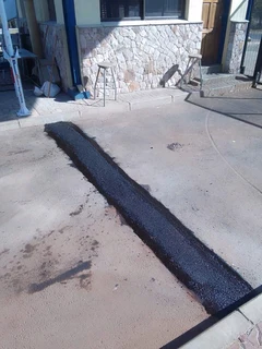 Tar surfacing and brick paving