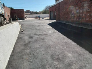 Tar surfacing and brick paving