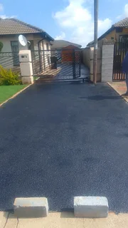 Tar surfacing and brick paving