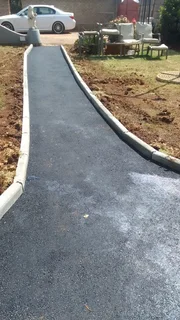 Tar surfacing and brick paving