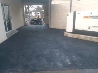 Tar surfacing and brick paving
