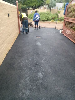 Tar surfacing and brick paving