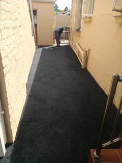 Tar surfacing and brick paving