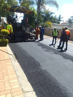 Tar surfacing and brick paving