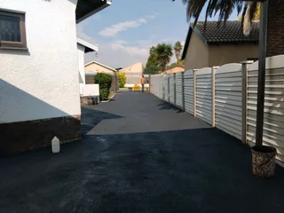 Tar surfacing and brick paving