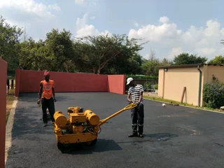 Tar surfacing and brick paving