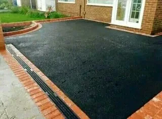 Tar surfacing and brick paving