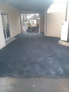 Tar surfacing and brick paving