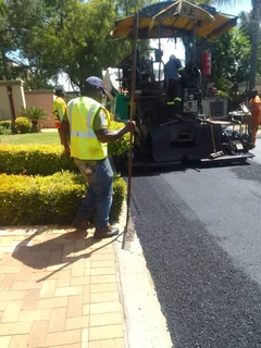 Tar surfacing and brick paving