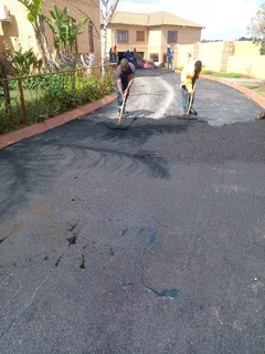 Tar surfacing and brick paving