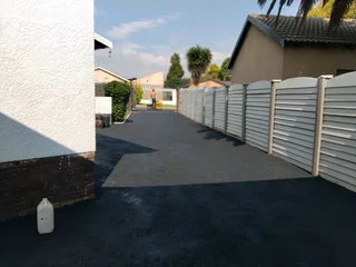 Tar surfacing and brick paving